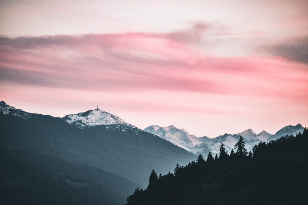 snow capped mountains under the cloudy skies